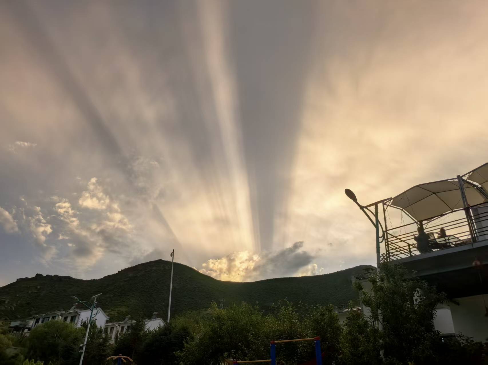Sun rays over the mountain at dusk