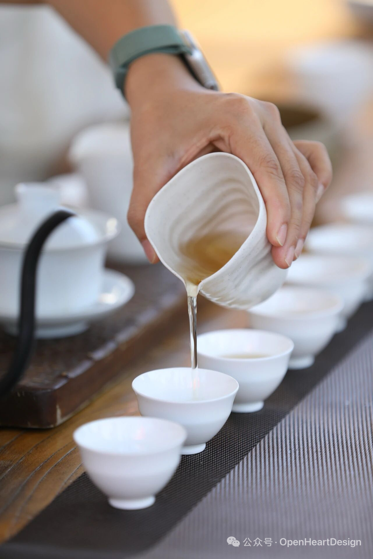 Pouring tea into cups in a quiet setting