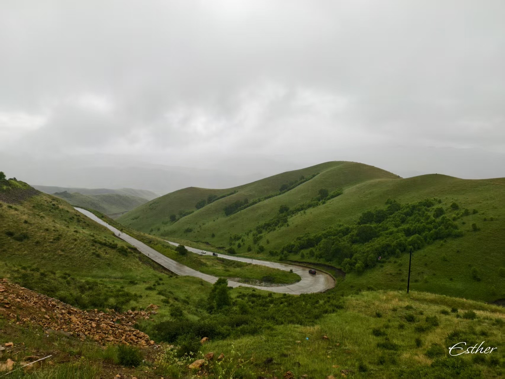 Winding road through green mountain hills